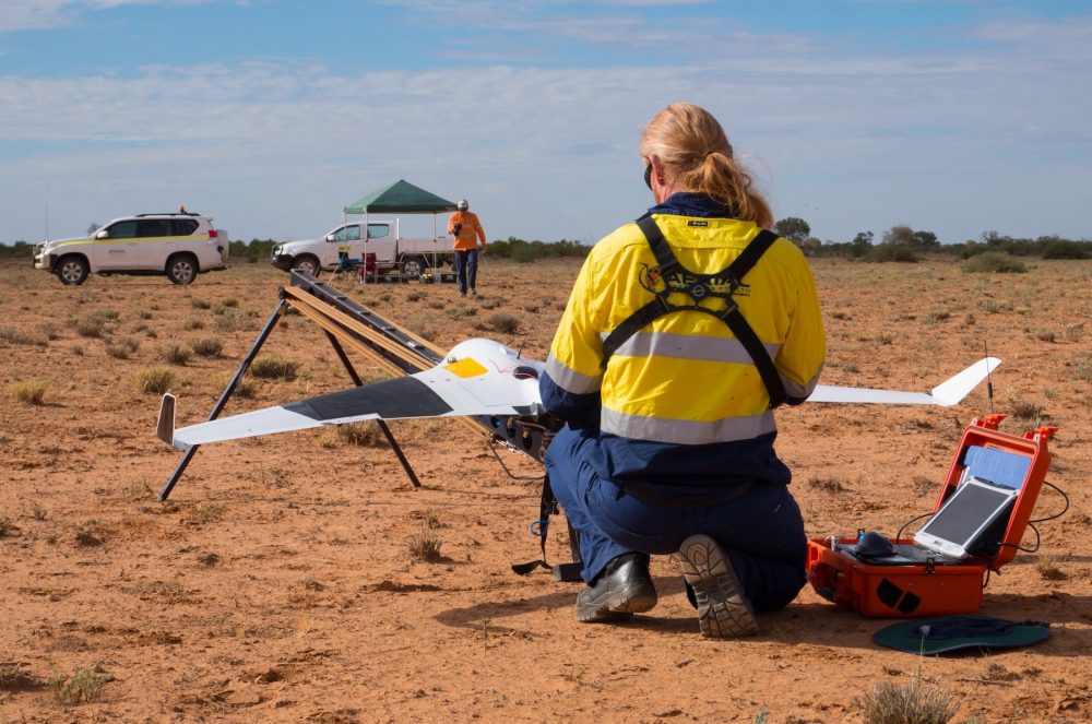 Drone pilot flying a fixed wing drone type in Australian outback.